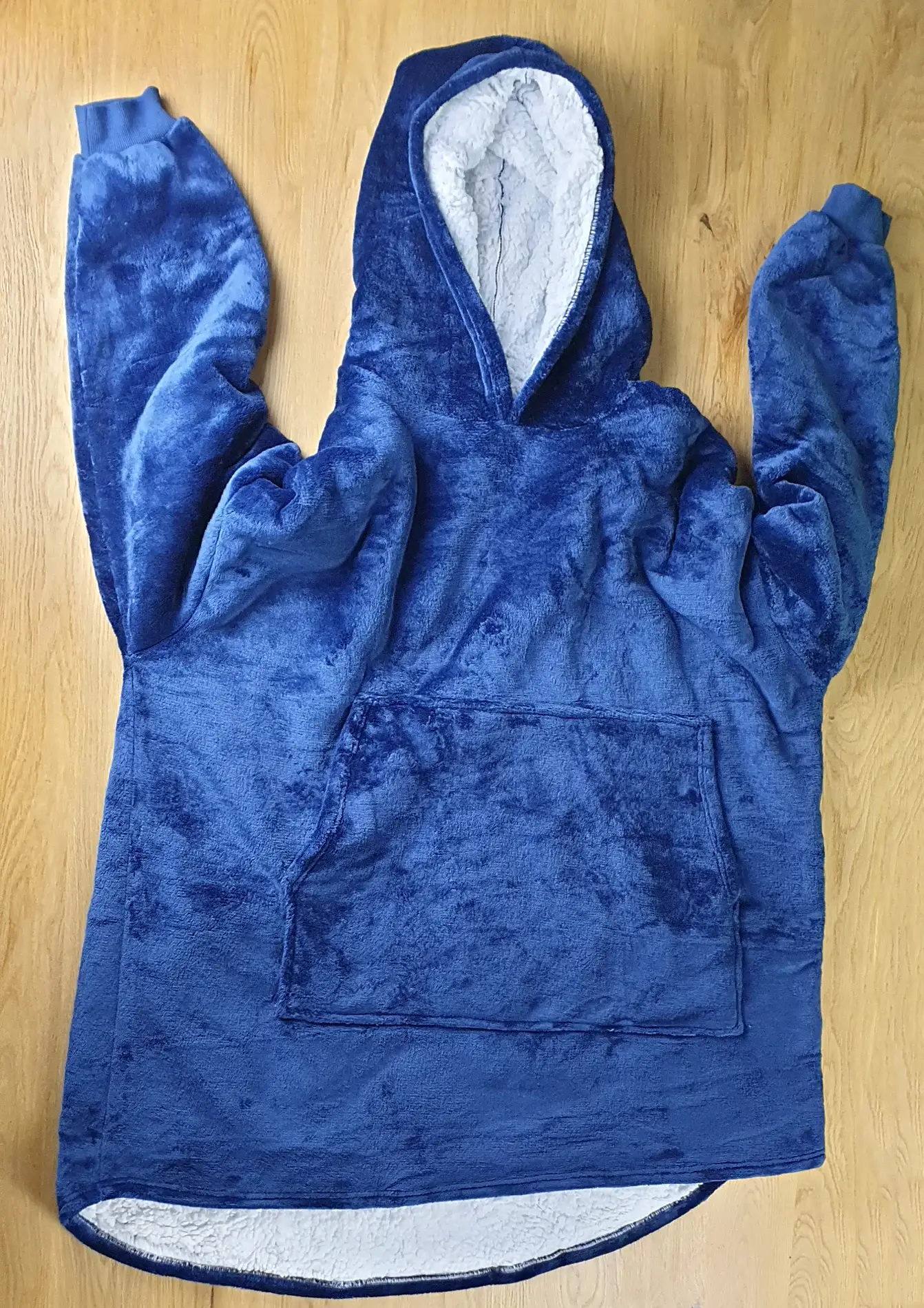 Ein Photo des Decken-Hoodies im Blauen-Design auf den Tisch gelegt mit der Vorderseite zur Kamera