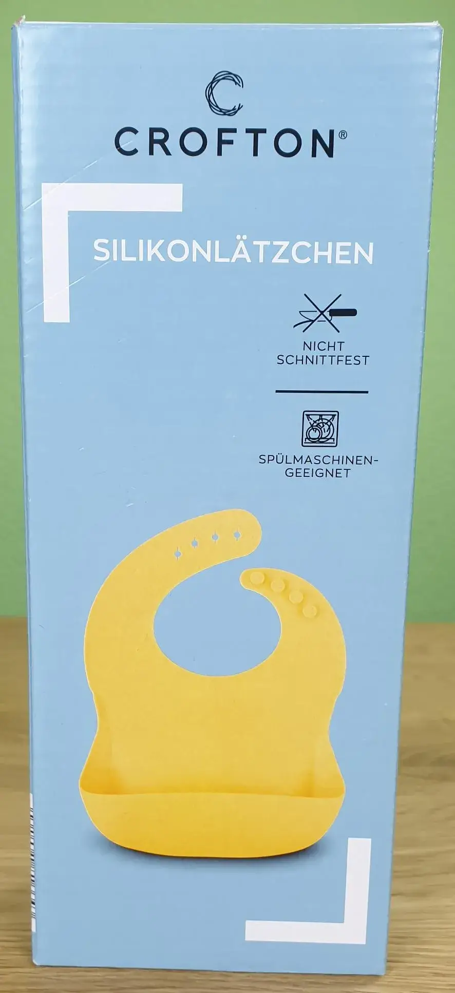 CROFTON Silikonlätzchen in seiner Verpackung von vorne.