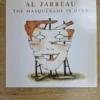 Vorderseite der Vinyl LP Al Jarreau - The Masquerade Is Over mit Illustration einer Holzmaske
