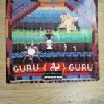 Vorderseite der Guru Guru Vinyl LP Hülle auf Brain Metronome mit Kunsthandwerk-Motiv und SOUNDS Magazin Sticker