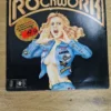 Vorderseite der Vinyl Doppel-LP Rockwork von 1975 mit Illustration einer Frau im Jeanshemd und Bandlogos